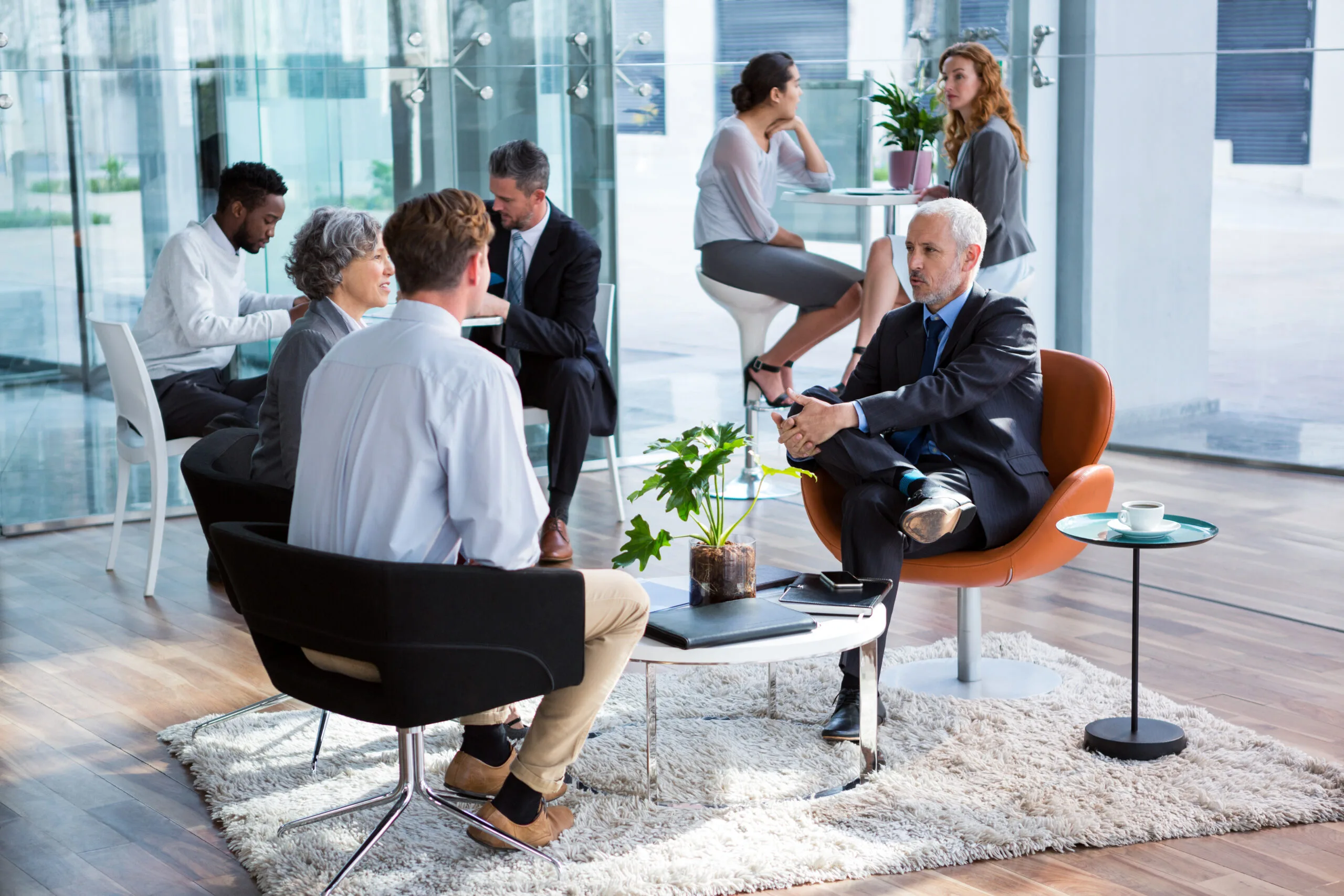 Business executive interacting with each other in office Mahad Manpower Recruitment Agencies in Dubai